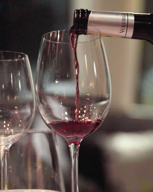 De la vigne au verre Gros plan sur verre à pied dans lequel est versé du Vin rouge du Maroc (chais de Volubilia)